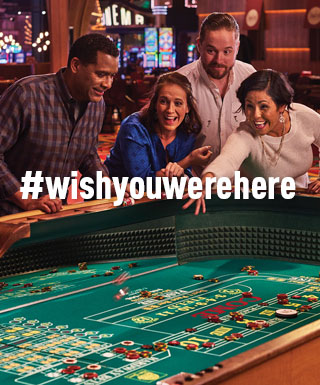 group playing craps with text "#WishYouWereHere"
